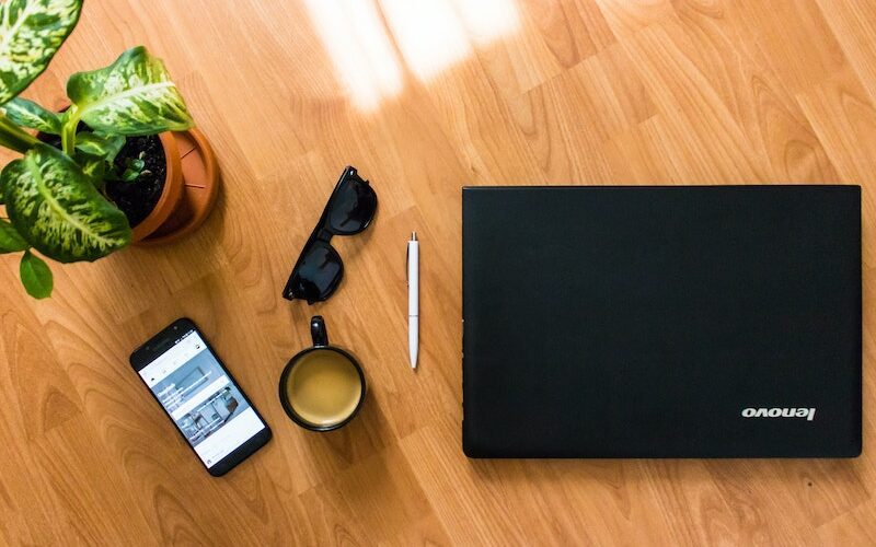 Laptop Beside Headphones and Camera
